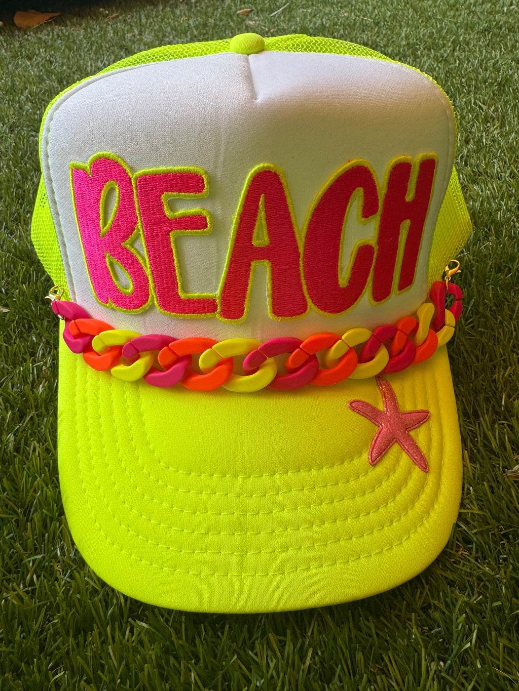 BEACH hot pink with neon trim embroidered patch on neon trucker hat with neon hat chain