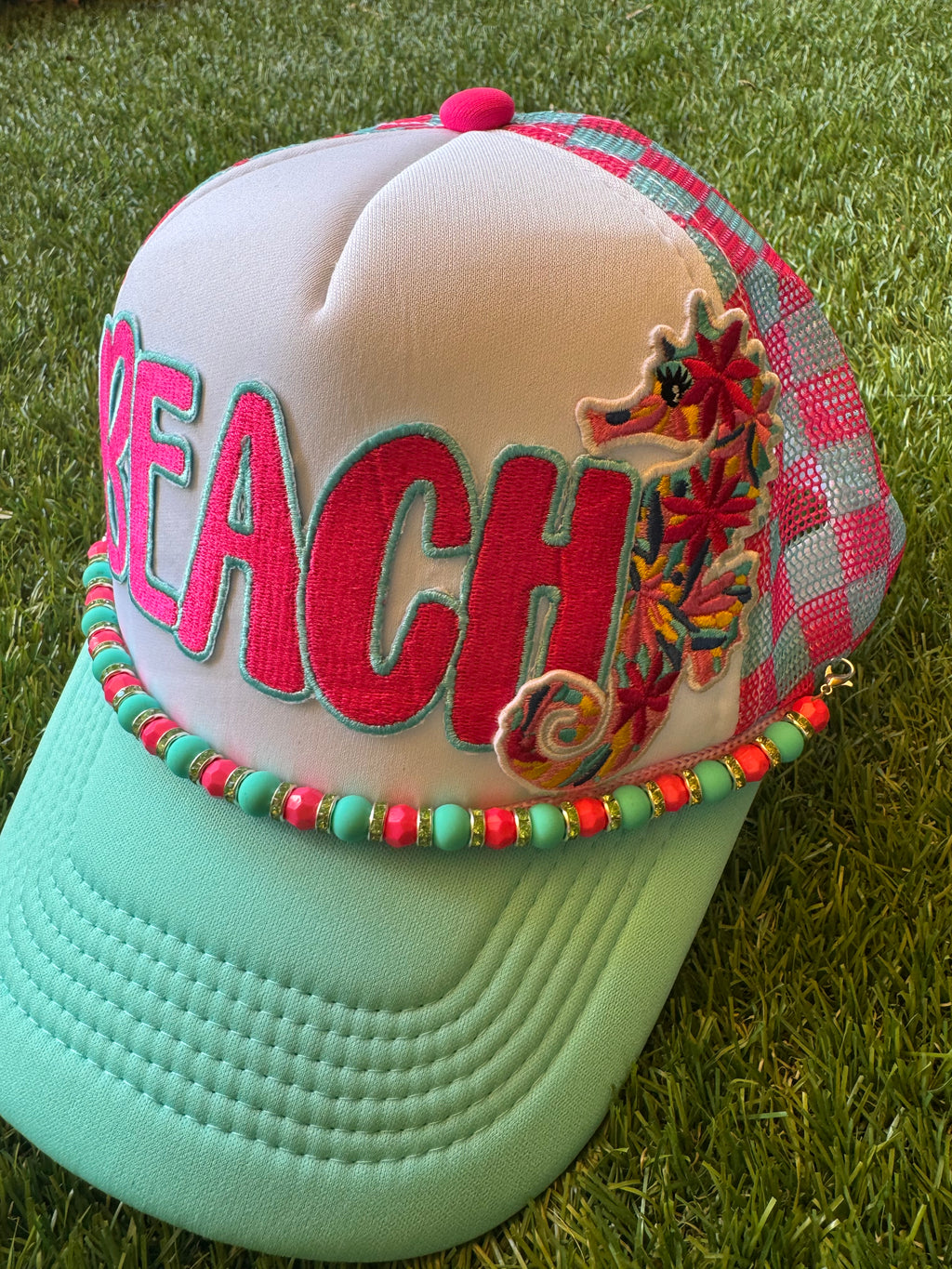 BEACH hot pink with teal trim on teal and hot pink trucker hat with hat chain and seahorse embroidered patch