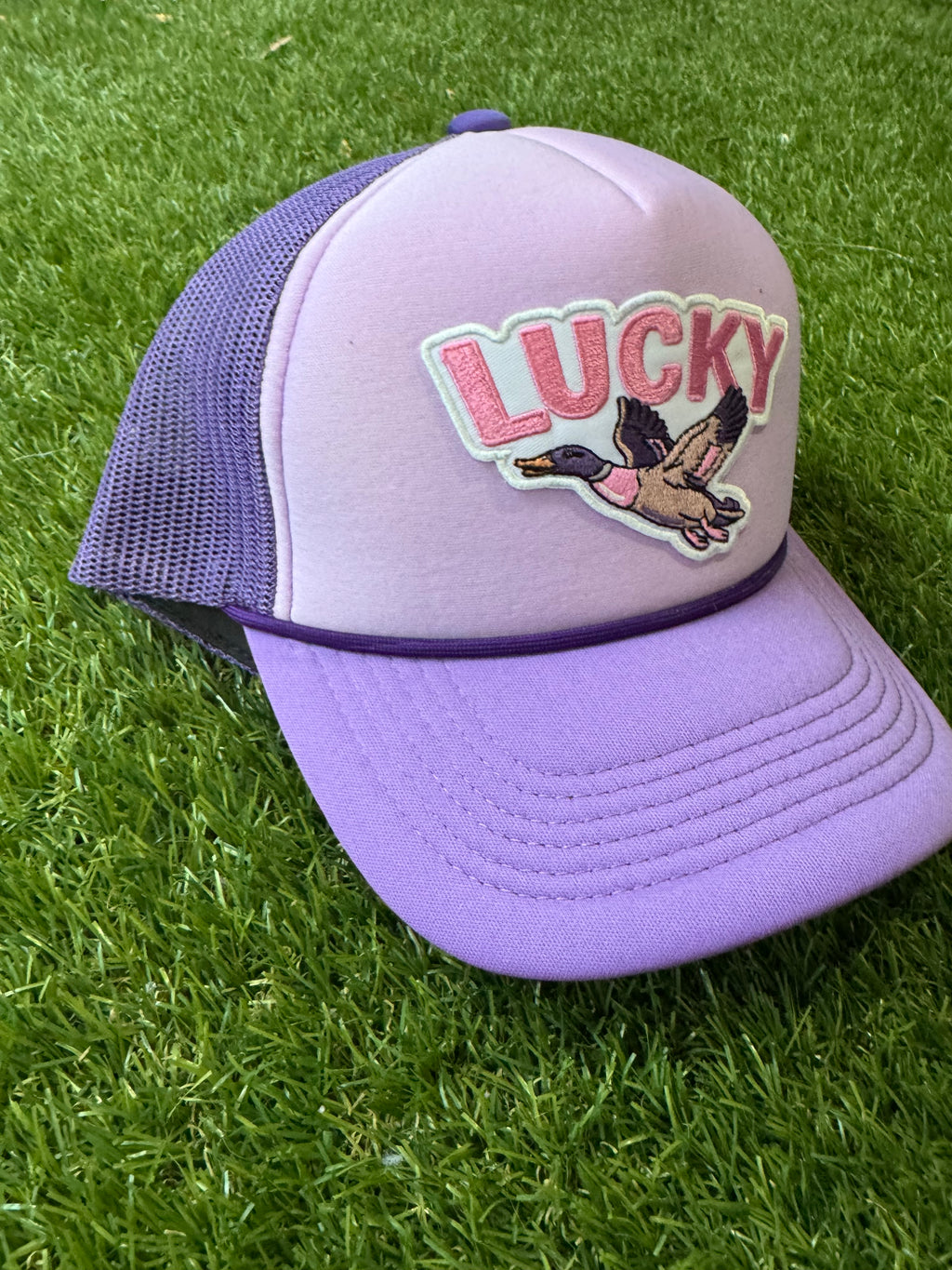 Lucky Duck on tricolor purple mesh trucker hat with magna pony