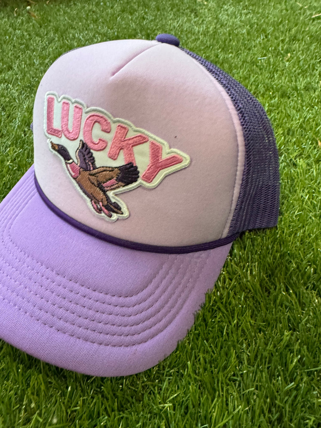 Lucky Duck on tricolor purple mesh trucker hat with magna pony