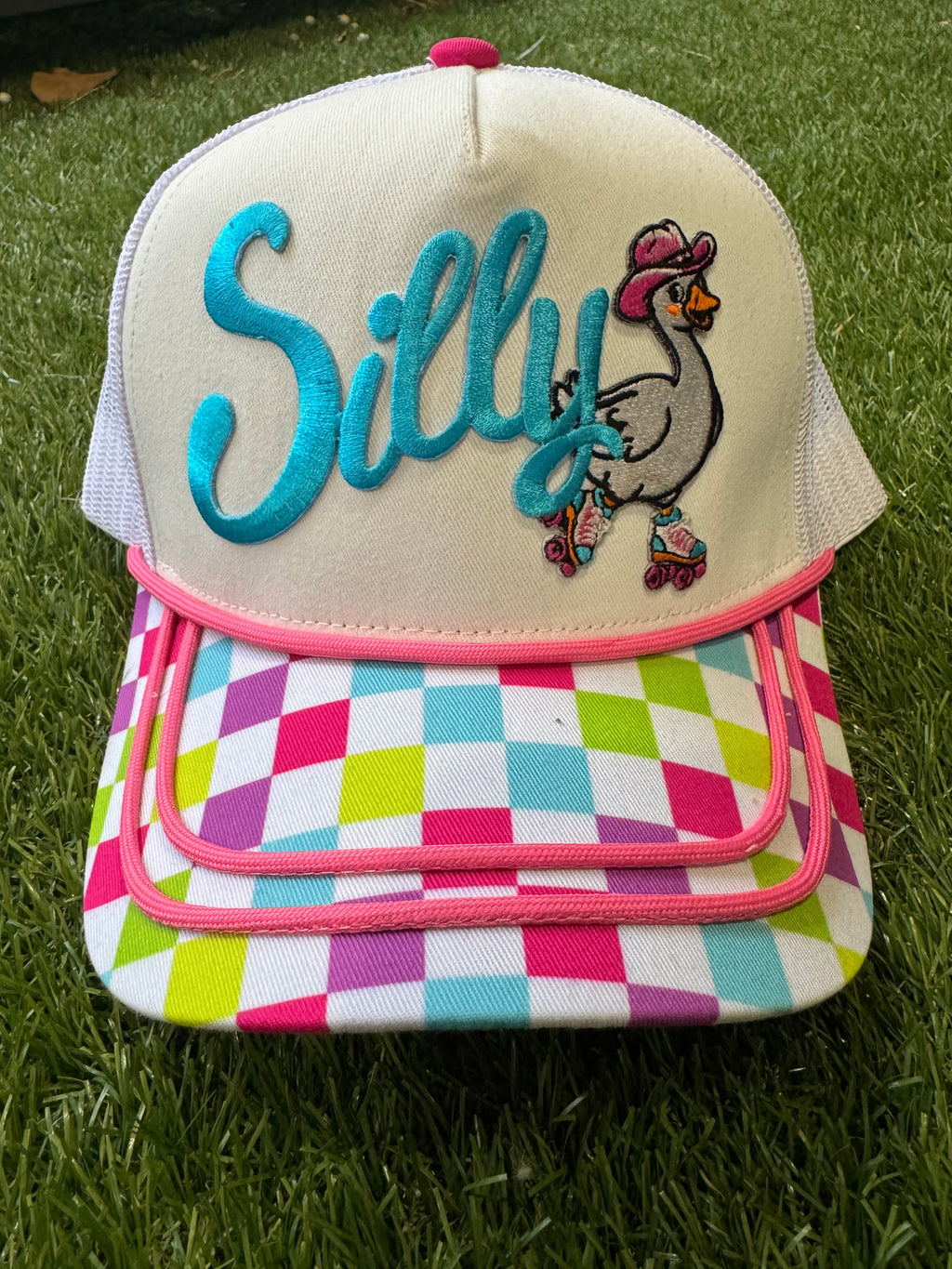 Silly Goose on skates on multicolored checkered brim canvas trucker hat