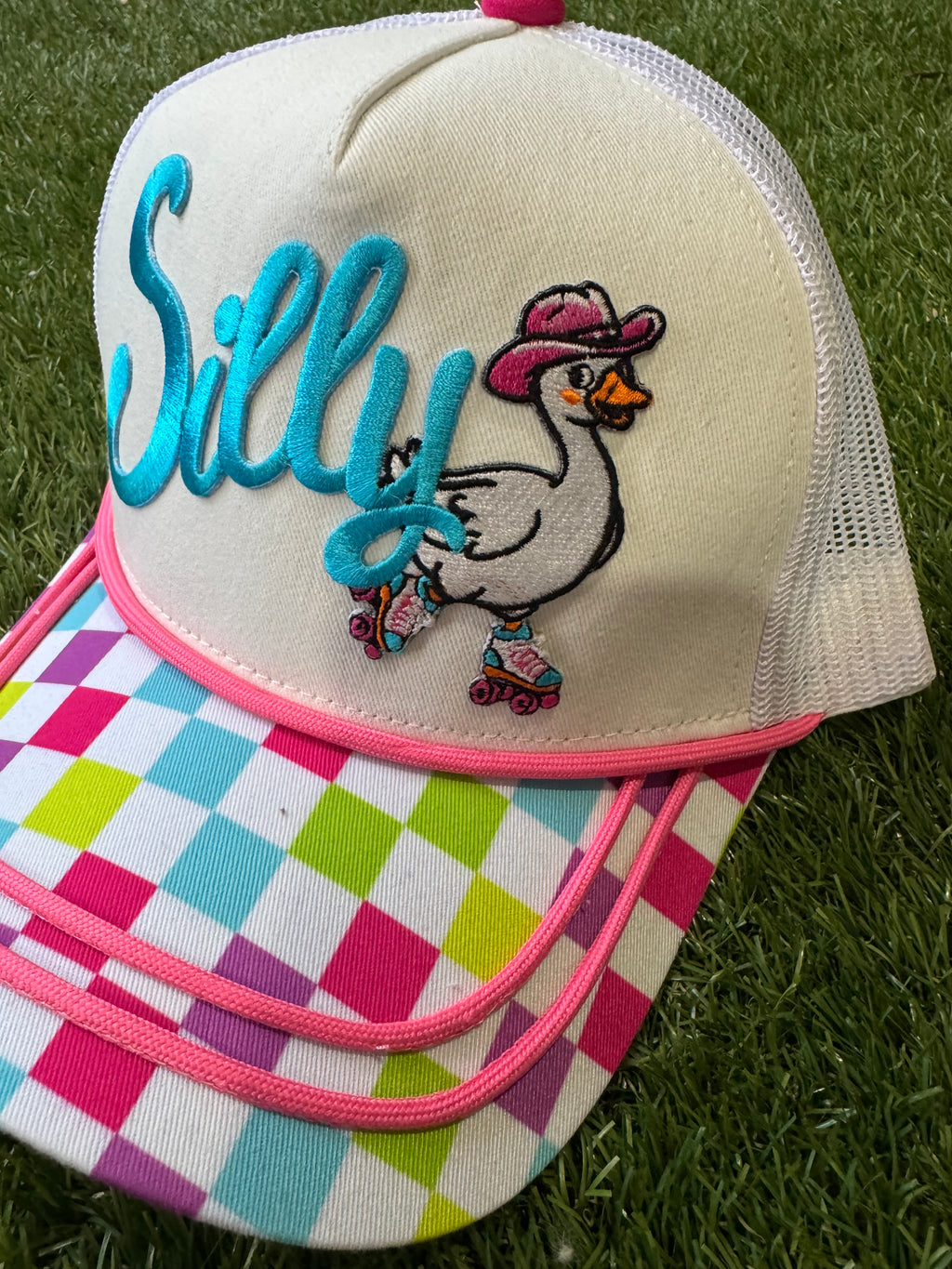 Silly Goose on skates on multicolored checkered brim canvas trucker hat