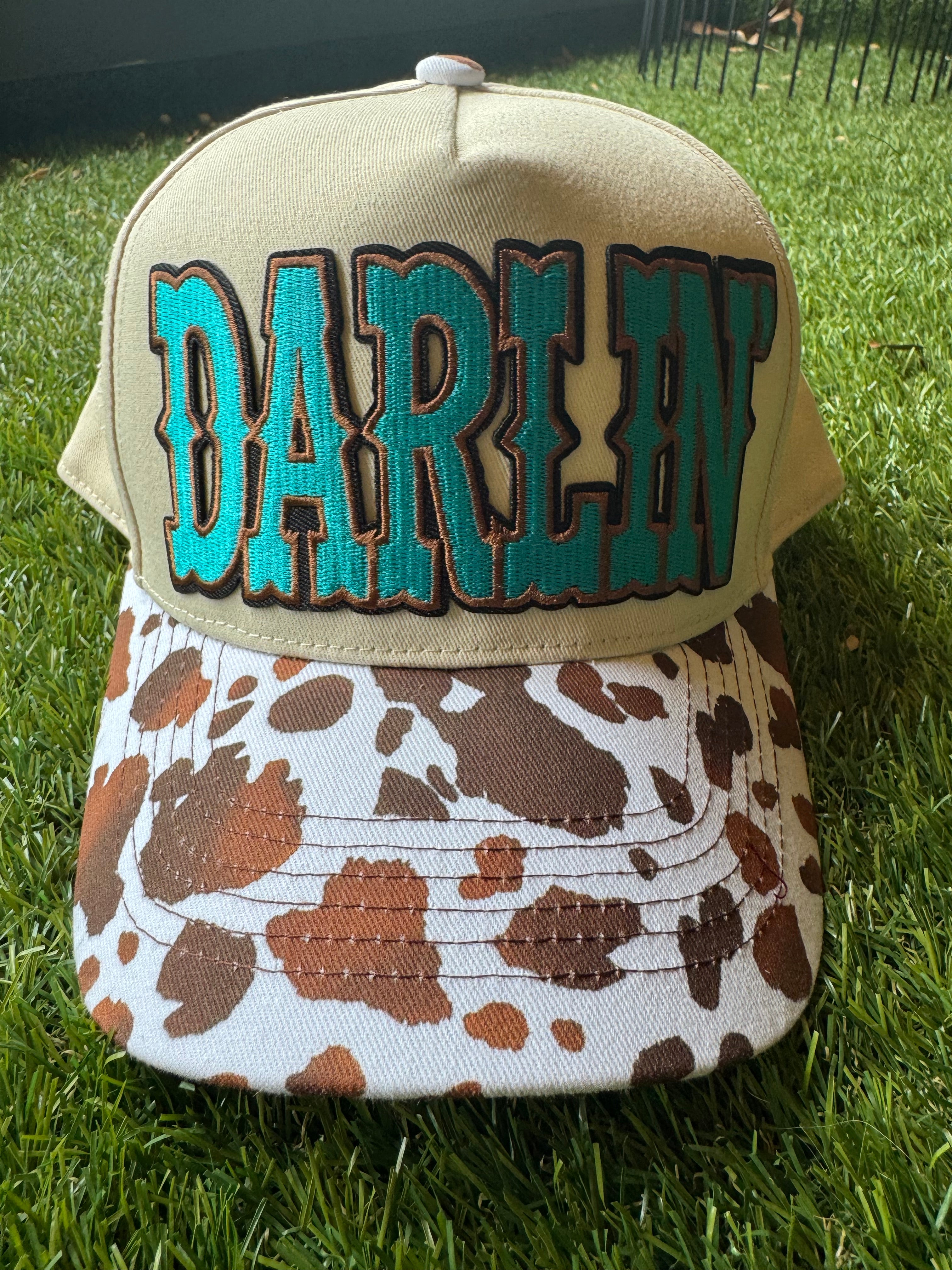 Darlin' embroidered patch on canvas cow brim trucker hat