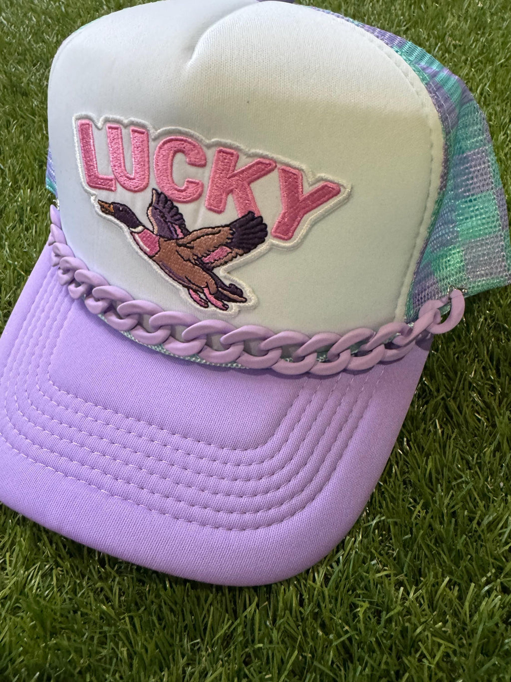 Lucky Duck on checkered teal and purple with purple hat chain