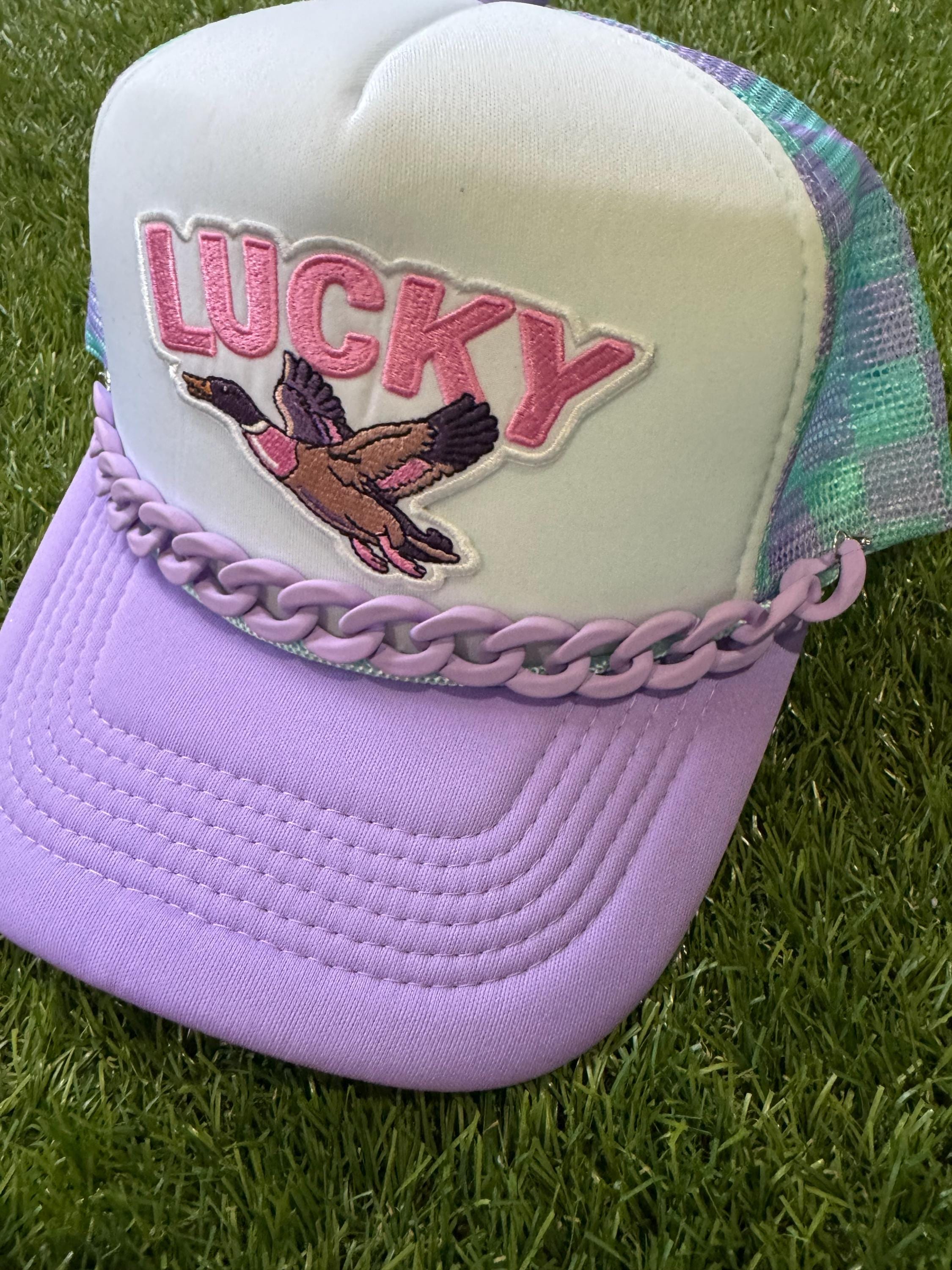 Lucky Duck on checkered teal and purple with purple hat chain
