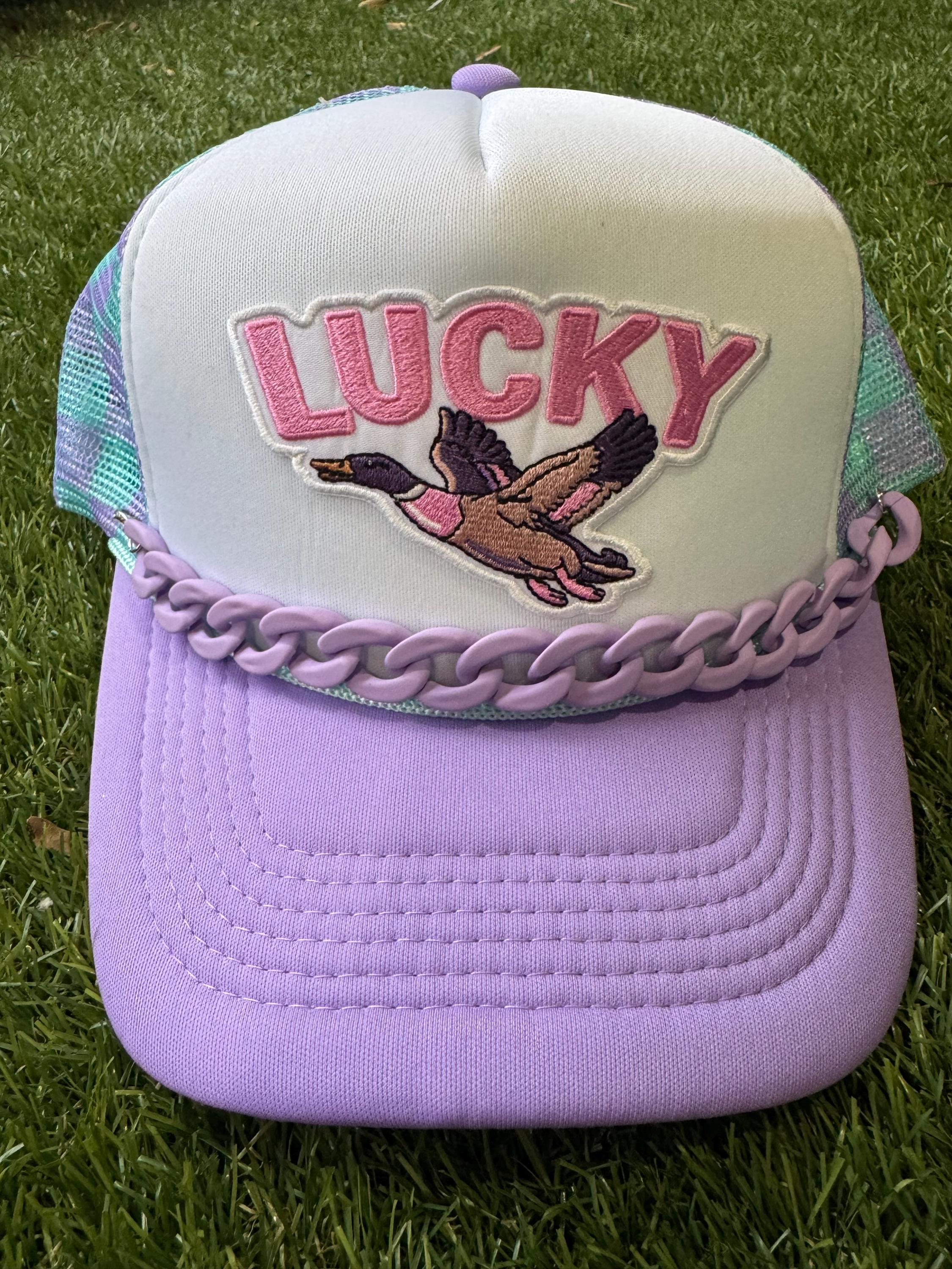 Lucky Duck on checkered teal and purple with purple hat chain