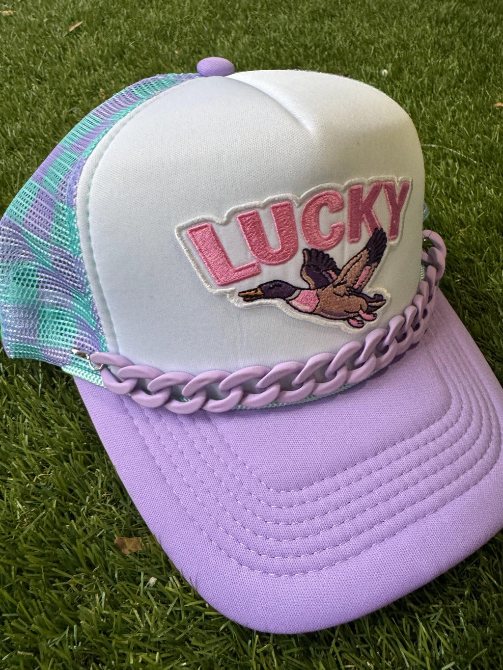 Lucky Duck on checkered teal and purple with purple hat chain